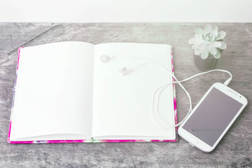 Flat lay of book, headphones with mobile phone and coffee cup  on old wooden table,vintage tone,romantic  for relax day