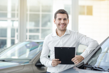 Young Man in a Car Rental Service Transportation Concept