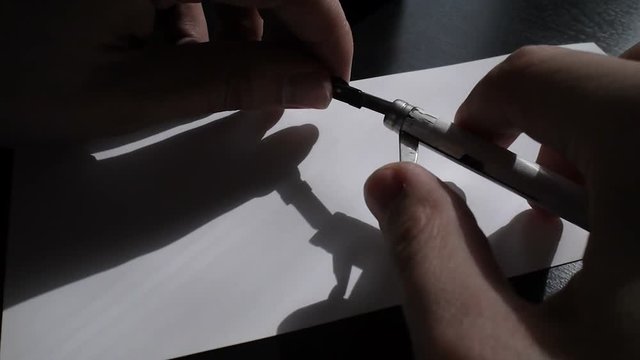 The artist inserts the pen in calligraph