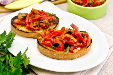 Bruschetta with tomatoes and peppers in plate on table
