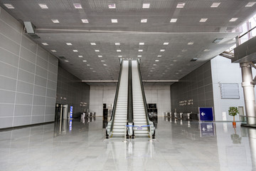 Futuristic metal escalator for lifting people in a modern shopping mall   © ironstuffy