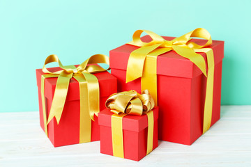 Gift boxes with ribbon on white wooden table