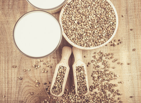 Hemp milk, seeds on wooden background . Close Up .