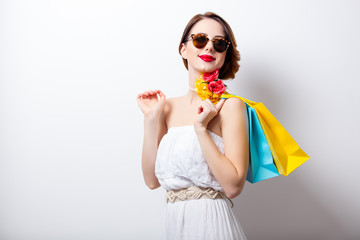 portrait of beautiful young woman with colorful shopping bags on the wonderful studio background
