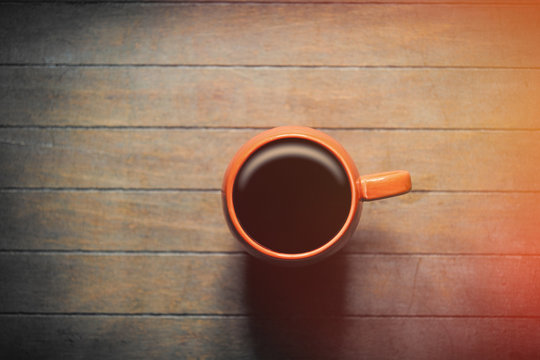 photo of cup of fresh coffee on the wonderful brown wooden background