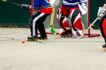 hockey players scramble in front of the goal