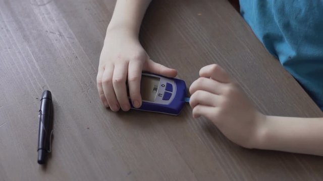 Boy diabetic measures blood glucose level of blood sugar #2