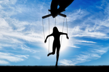 Hand controls the woman's marionette