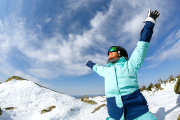Girl snowboarder enjoys the ski resort