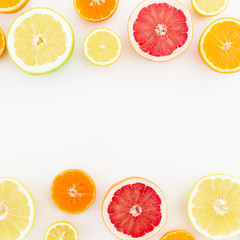 Food Frame of mix with fresh lemon, orange, mandarin, grapefruit and sweetie on white background. Flat lay, top view.