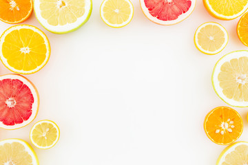 Food Frame of tropical summer mix with fresh lemon, orange, mandarin, grapefruit and sweetie on white background. Flat lay, top view.