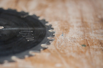 circular saw on wooden table macro picture