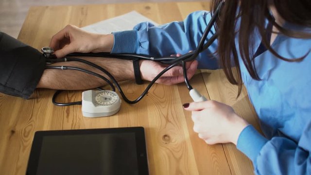 Female doctor measure blood pressure, close up 4k