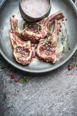 Raw marinated lamb chops  for barbecue grilling or frying , top view, close up, copy space