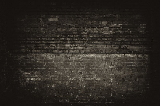 Dark room with brick wall background
