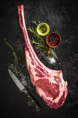 Zelfklevend Fotobehang Dry aged raw tomahawk beef steak © Alexander Raths