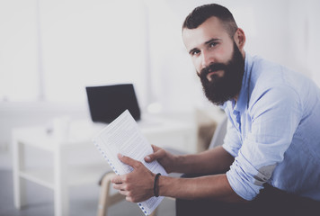 Fototapeta premium Young businessman sitting on chair in office