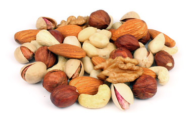 mix almonds, cashew nuts, hazelnut, peanuts, walnuts, pistachio in wood plate isolated on white background