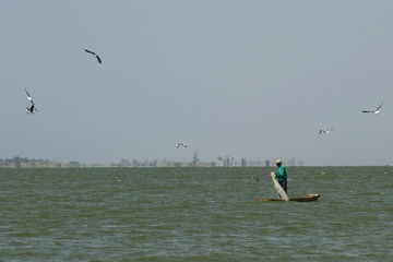Fototapeta na wymiar Man fishing on a boat in Africa