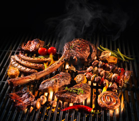 Assorted delicious grilled meat on a barbecue - obrazy, fototapety, plakaty