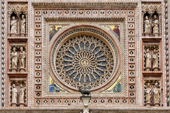 The Orvieto Cathedral central rose window. This cathedral is a 14th-century Roman Catholic cathedral dedicated to the Assumption of the Virgin Mary and situated in the town of Orvieto in Umbria, Italy