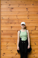 teenage girl in sports clothes posing in front of camera