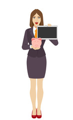 Businesswoman holding a piggy bank and showing blank digital tablet PC