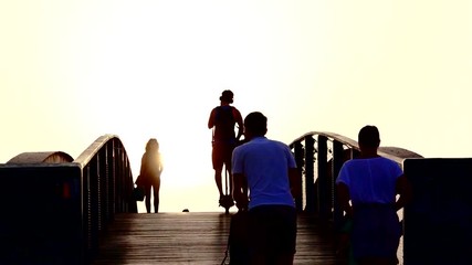 Walking on a wooden bridge. Clouds and legs. Sun.