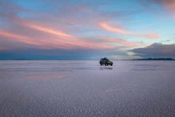 Off-road vehicle at sunrise in Salar de Uyuni salt flat - Potosi Department, Bolivia