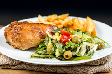 Fresh chicken steak with tomatoes and french fries
