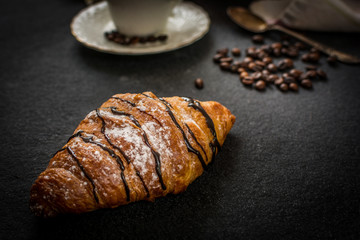 Croissant with chocolate and coffee