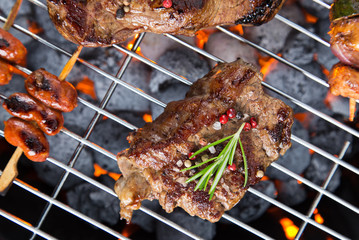 Barbecue grill with beef steaks, close-up.