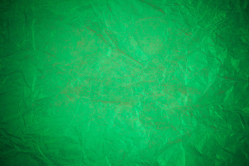 Obraz na płótnie Canvas Crumpled green paper recycling background.
