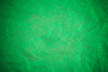 Crumpled green paper recycling background.