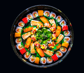 Japanese Sushi contains salmon, shrimp and rice with black background