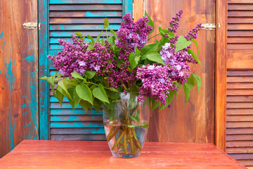 Lilac on colored wooden background