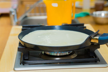 Fototapeta na wymiar Frying pan with fresh homemade pancake