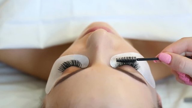 Eyelash Extension Procedure. Woman Eye with Long Eyelashes. Lashes, close up, selective focus.