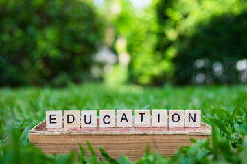 Education concept - wooden alphabet on old vintage book