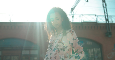 Portrait of a young woman walking in the city streets. Portrait of a young African American woman, outdoors. 