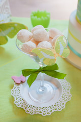 Coconut sweet cookies in a piastre decorated with a green ribbon with a bow and decorative beautiful butterfly