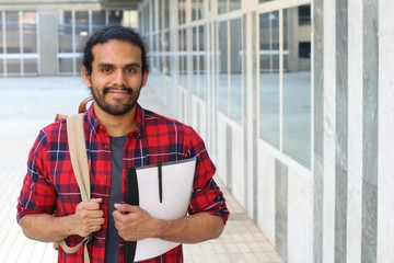 College student with backpack and books posing on campus - Stock image with copy space