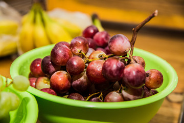 Red grapes on a wooden table.