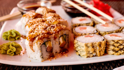 Sushi roll with salmon and tempura shrimp and sesame