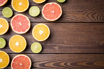 Colorful citrus halves on wooden table. Food background