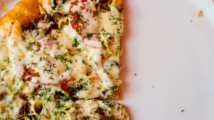 Part of a delicious aromatic pizza on a plate