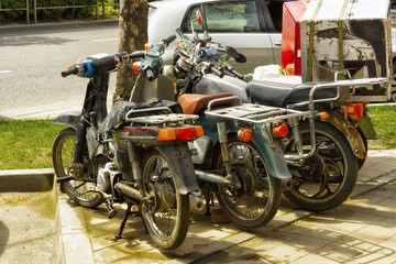 Obraz na płótnie Canvas Mopeds and scooters parked
