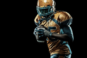 American football sportsman player isolated on black background © Mike Orlov