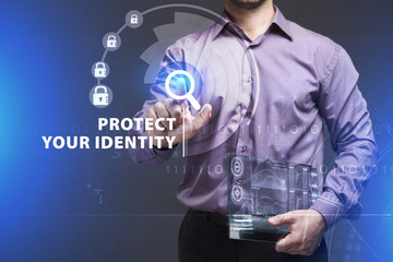 Business, Technology, Internet and network concept. Young businessman working on a virtual screen of the future and sees the inscription: Protect your identity