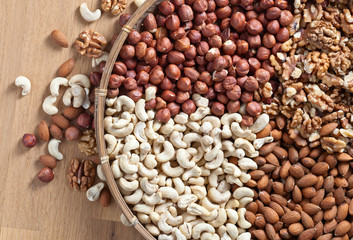 Different nuts in old wooden dish